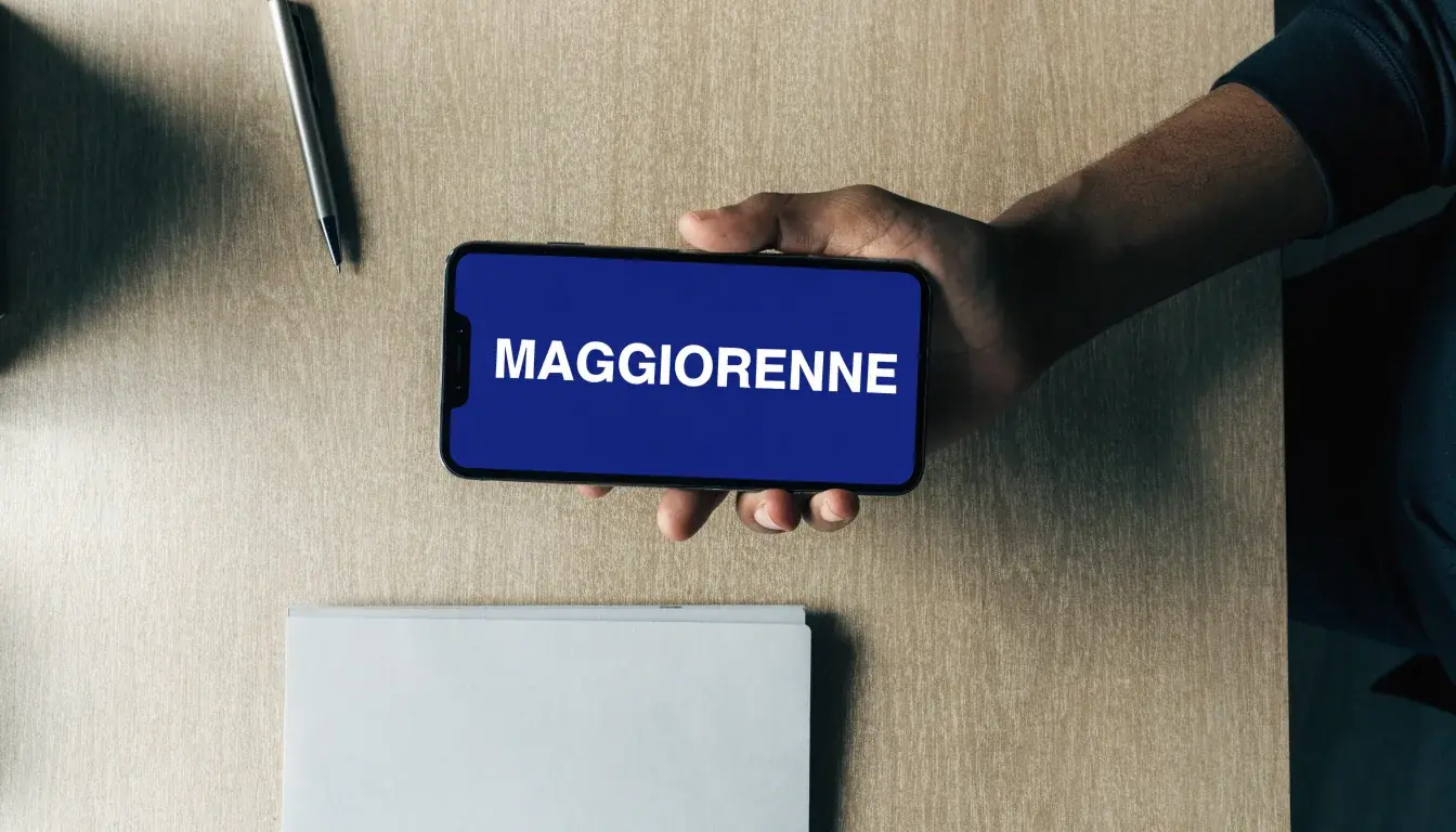 Un foglio di concessione in carta con un timbro rosso, appoggiato su una scrivania di legno accanto a una penna